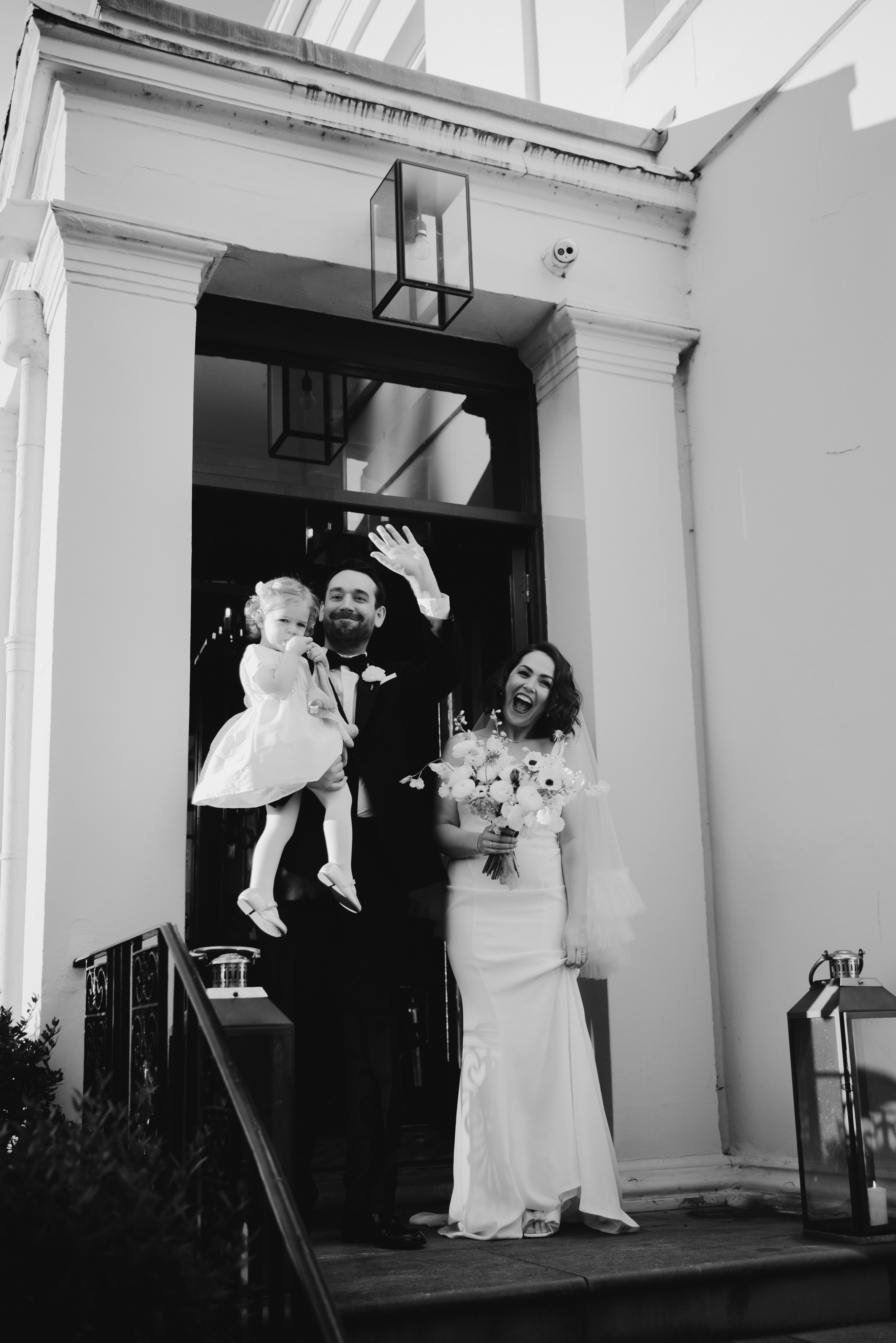 Happy wedding couple smiles outside no.131 Cheltenham