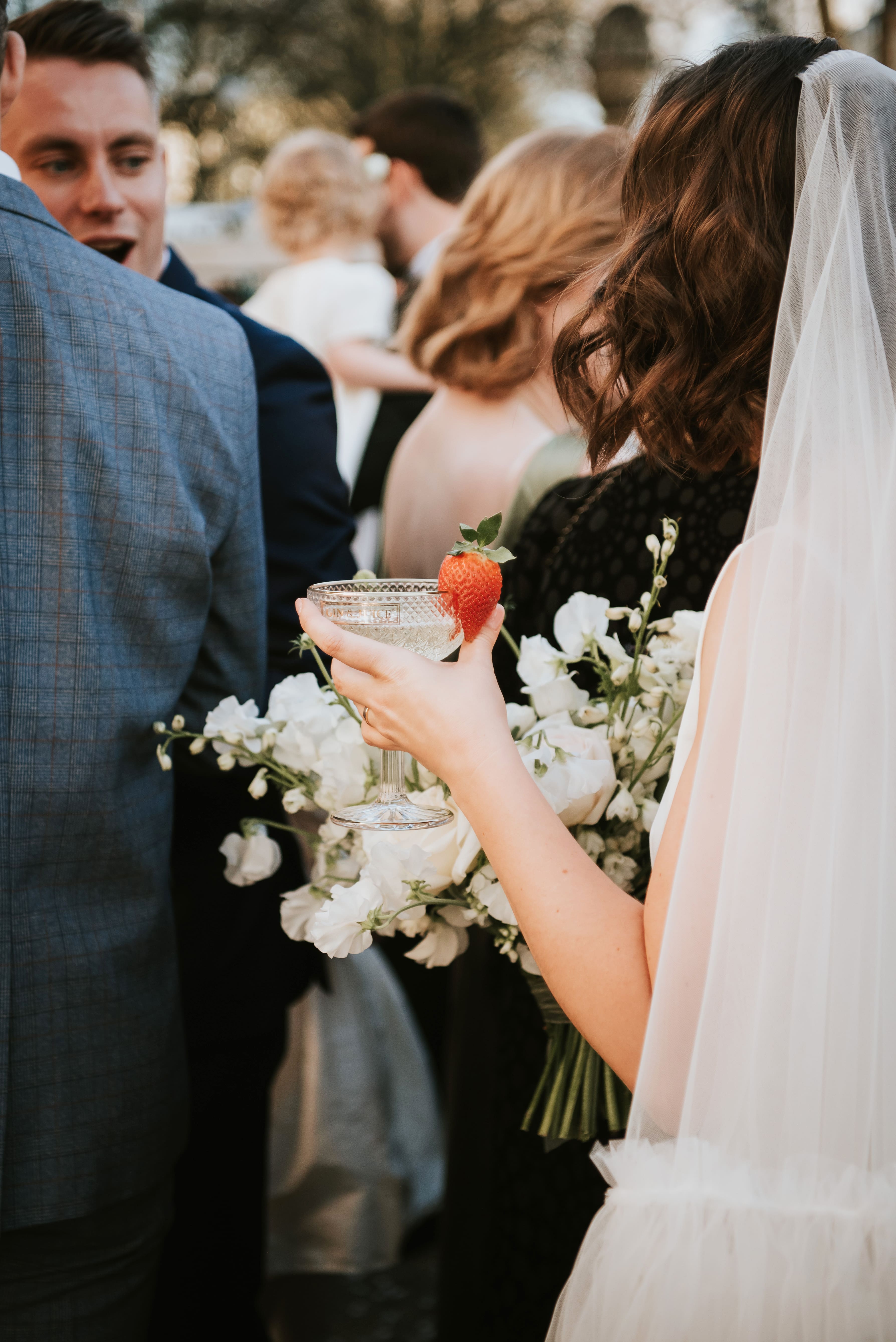 Female holding a drink during a wedding at no.131 Cheltenham